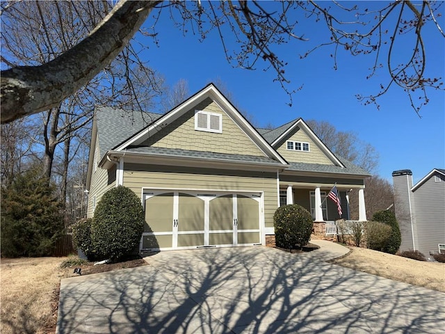 craftsman-style home with a garage, concrete driveway, and a porch