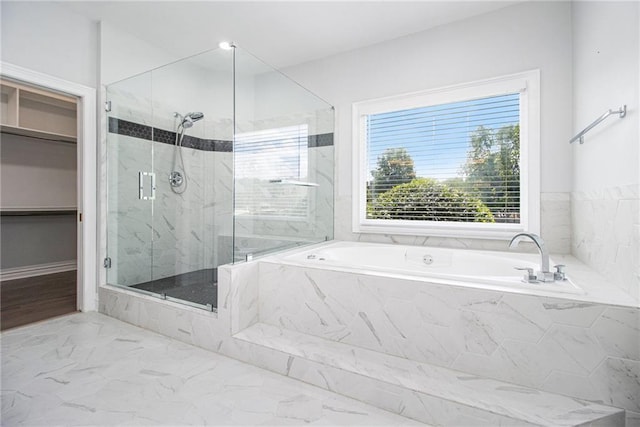 5690 Rutland Trce, Lithonia, GA 30058 - bathroom featuring a marble finish shower, a bath, marble finish flooring, and a walk in closet