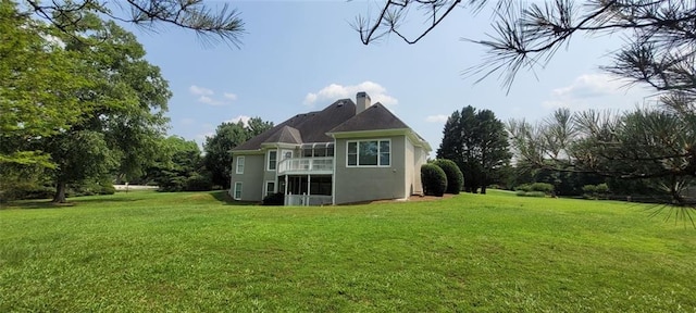 5690 Rutland Trce, Lithonia, GA 30058 - rear view of property featuring a balcony, a yard, stucco siding, and a chimney