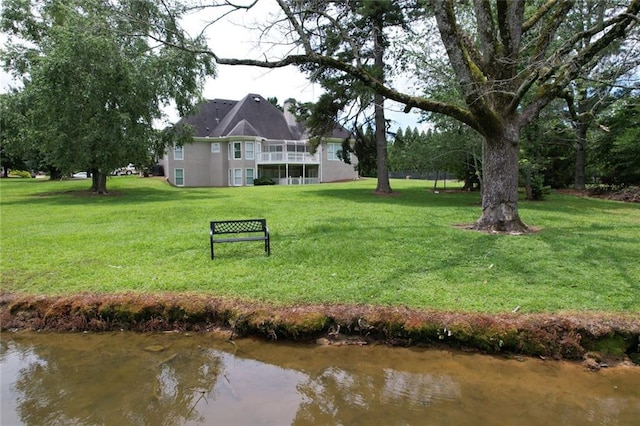 5690 Rutland Trce, Lithonia, GA 30058 - view of grassy yard with a balcony and a water view