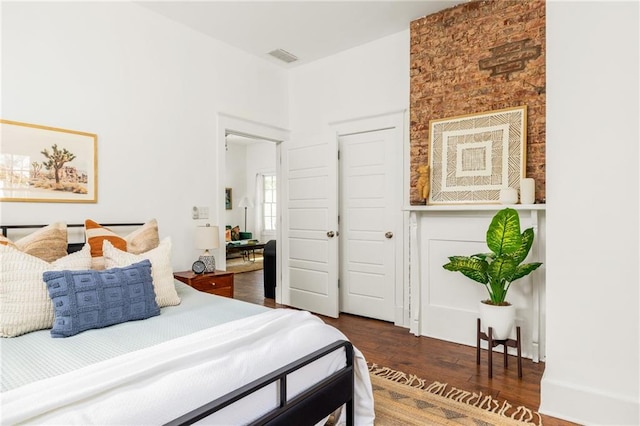 bedroom with visible vents and wood finished floors