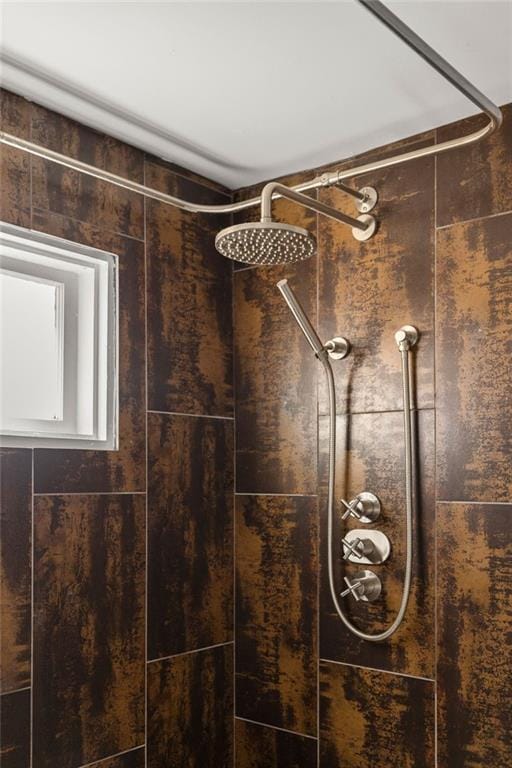 interior details featuring tiled shower