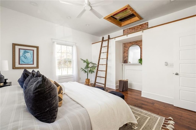 bedroom featuring baseboards, wood finished floors, and a ceiling fan