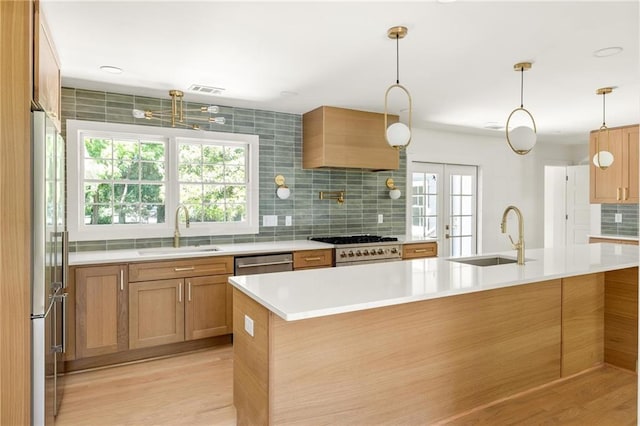 762 Rockbridge Rd NW, Lilburn, GA 30047 - kitchen featuring a sink, premium appliances, tasteful backsplash, and light countertops