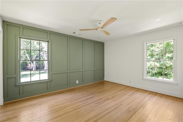 762 Rockbridge Rd NW, Lilburn, GA 30047 - spare room featuring a decorative wall, light wood-type flooring, ceiling fan, and baseboards