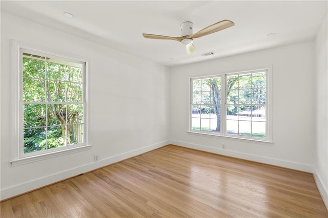 762 Rockbridge Rd NW, Lilburn, GA 30047 - unfurnished room with baseboards, light wood-style floors, and a ceiling fan
