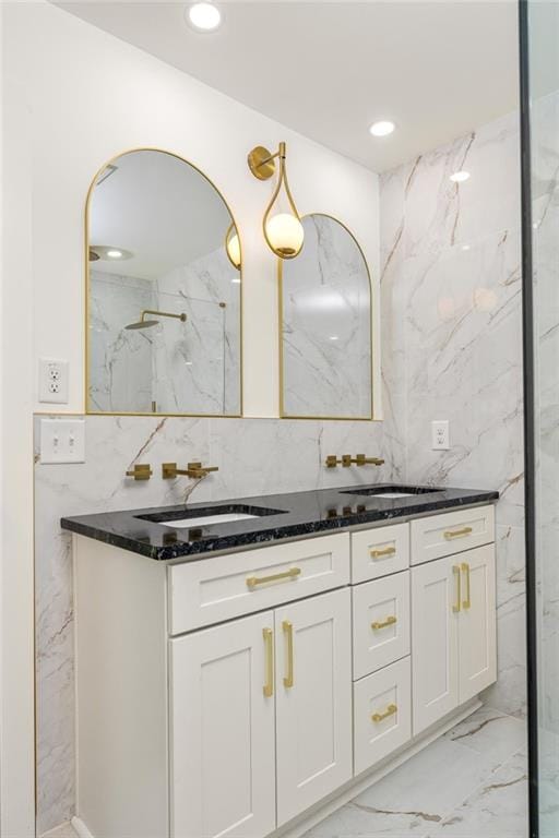 762 Rockbridge Rd NW, Lilburn, GA 30047 - full bathroom featuring double vanity, marble finish flooring, tasteful backsplash, recessed lighting, and tile walls