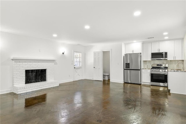 762 Rockbridge Rd NW, Lilburn, GA 30047 - unfurnished living room featuring recessed lighting, a sink, a fireplace, and baseboards