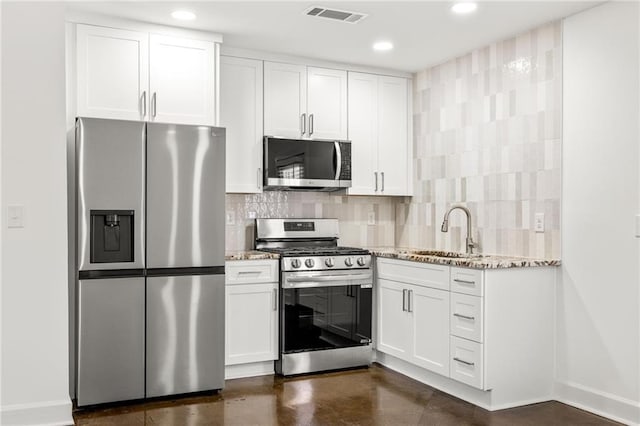 762 Rockbridge Rd NW, Lilburn, GA 30047 - kitchen with stainless steel appliances, a sink, light stone countertops, baseboards, and recessed lighting