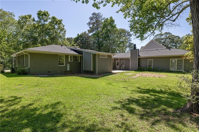 762 Rockbridge Rd NW, Lilburn, GA 30047 - back of house with a chimney and a lawn