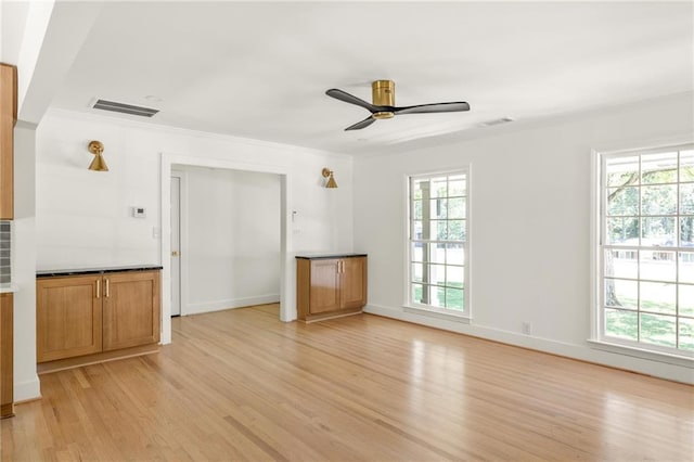762 Rockbridge Rd NW, Lilburn, GA 30047 - unfurnished living room featuring light wood-type flooring, ceiling fan, healthy amount of natural light, crown molding, and baseboards