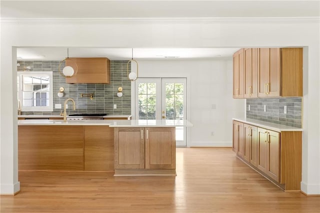762 Rockbridge Rd NW, Lilburn, GA 30047 - kitchen with decorative backsplash, light countertops, light wood-style floors, and crown molding