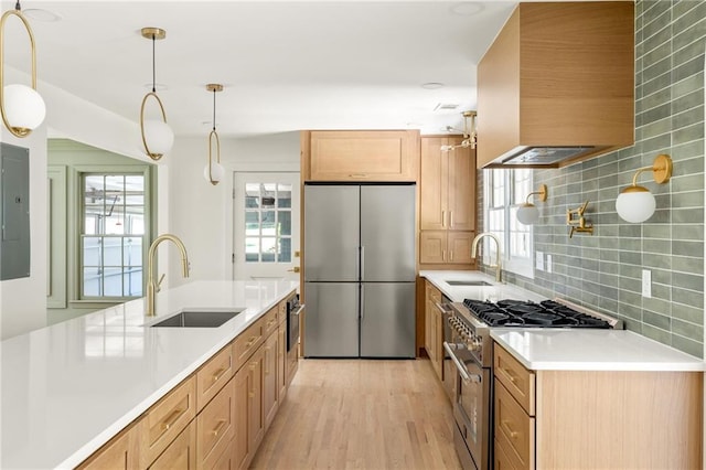 762 Rockbridge Rd NW, Lilburn, GA 30047 - kitchen with high end appliances, a sink, extractor fan, and light wood finished floors