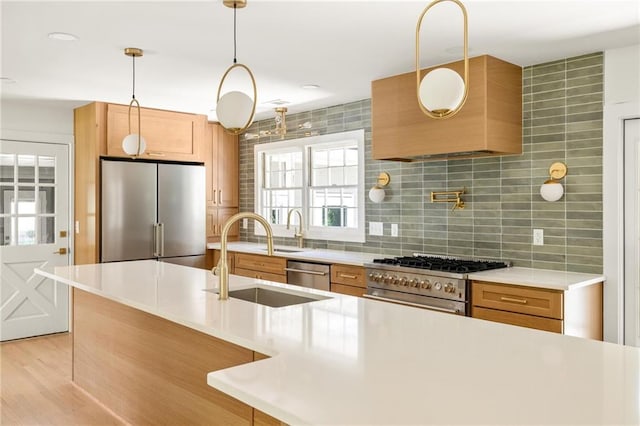 762 Rockbridge Rd NW, Lilburn, GA 30047 - kitchen with stainless steel appliances, a sink, light countertops, tasteful backsplash, and hanging light fixtures