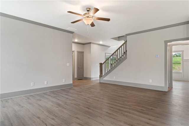 unfurnished living room featuring hardwood / wood-style flooring, ornamental molding, and ceiling fan