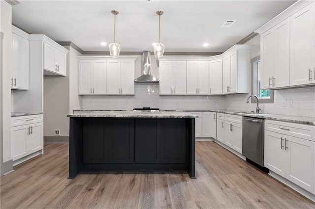 kitchen with wall chimney range hood, dishwasher, white cabinetry, light stone countertops, and decorative light fixtures