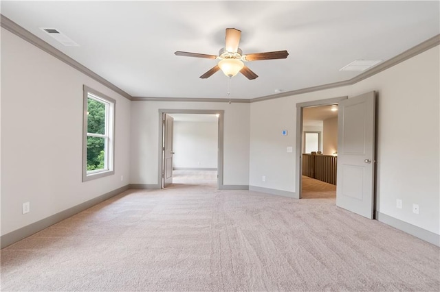 interior space with crown molding, light colored carpet, and ceiling fan