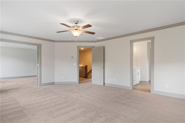 unfurnished room with crown molding, ceiling fan, and light carpet