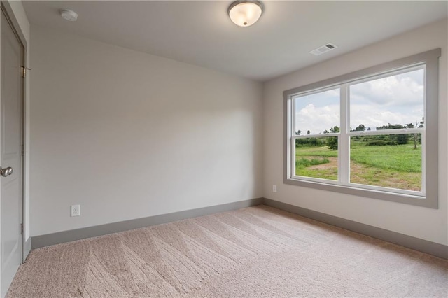 unfurnished room featuring light carpet