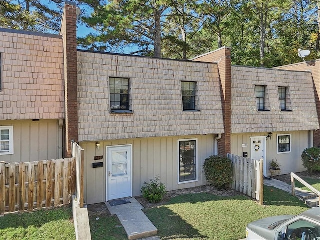 6429 Woodstone Way, Morrow, GA 30260 - townhome / multi-family property featuring mansard roof, a chimney, and board and batten siding