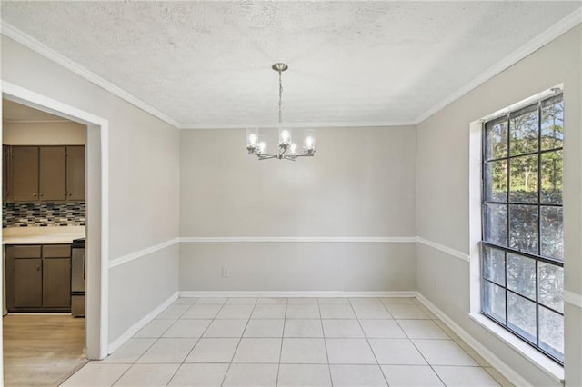 6429 Woodstone Way, Morrow, GA 30260 - unfurnished dining area with a chandelier, crown molding, baseboards, and a textured ceiling