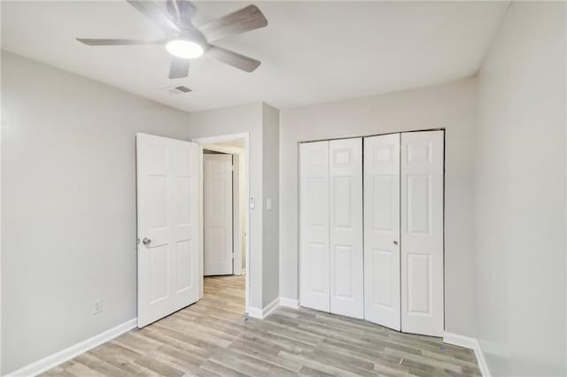 6429 Woodstone Way, Morrow, GA 30260 - unfurnished bedroom with light wood-type flooring, baseboards, ceiling fan, and a closet