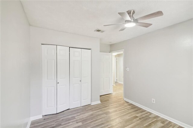 6429 Woodstone Way, Morrow, GA 30260 - unfurnished bedroom featuring light wood-type flooring, baseboards, a closet, and ceiling fan