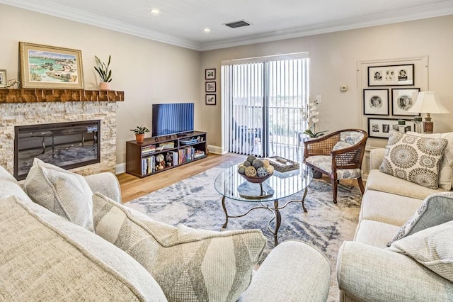 living room featuring a fireplace, crown molding, recessed lighting, light wood-style flooring, and baseboards