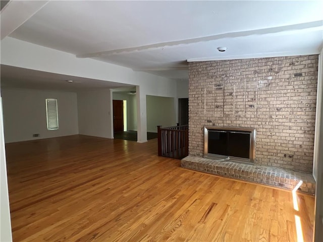 4968 Twin Branches Way, Dunwoody, GA 30338 - unfurnished living room with wood finished floors, a fireplace, and beam ceiling