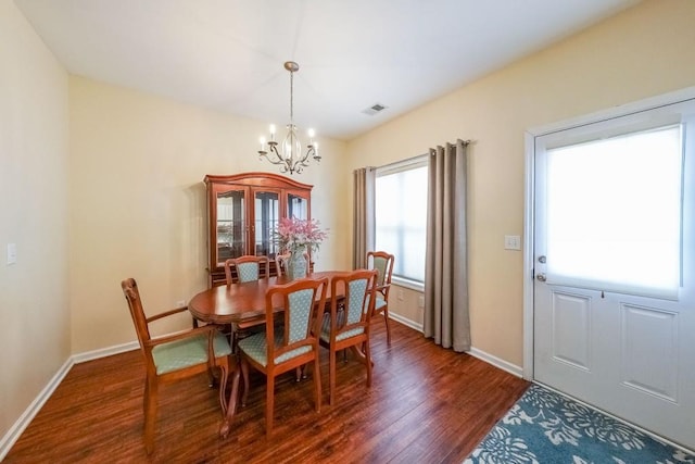 dining space featuring baseboards, a chandelier, dark wood-style floors, and visible vents