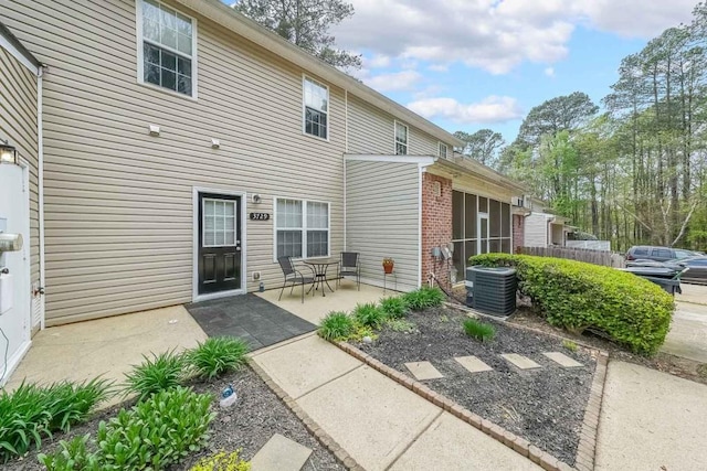 back of house with a patio, central AC unit, and a sunroom