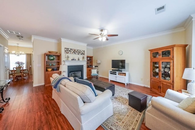 living area featuring visible vents, dark wood-type flooring, and a fireplace