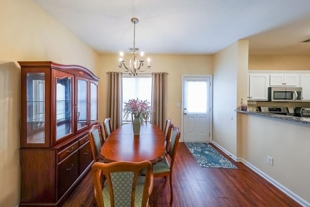 dining room featuring baseboards, an inviting chandelier, dark wood finished floors, and visible vents