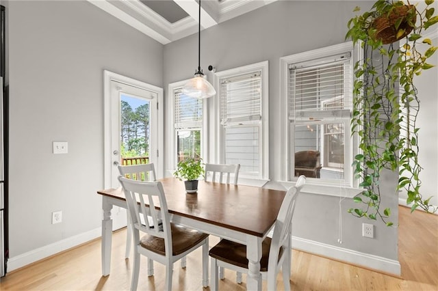 1797 Olive St SE, Atlanta, GA 30315 - dining space with baseboards, light wood-style flooring, and crown molding