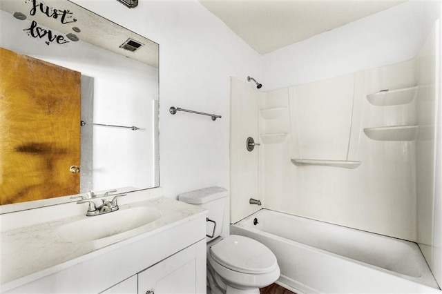 bathroom with toilet, vanity, and shower / washtub combination