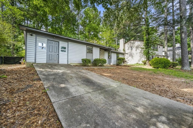 ranch-style home with concrete driveway