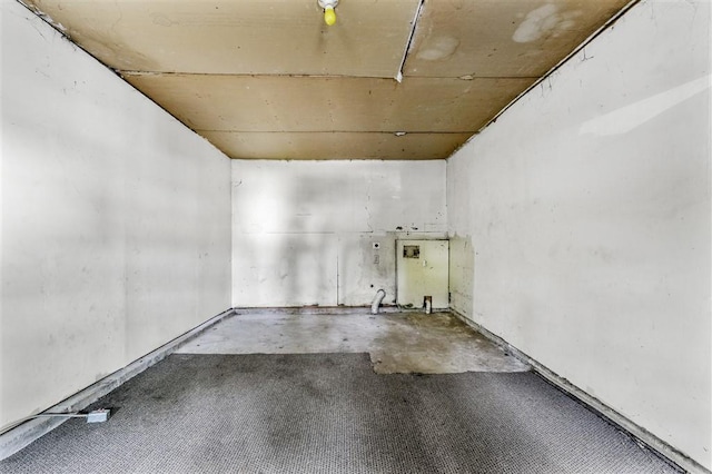 unfurnished room with concrete flooring