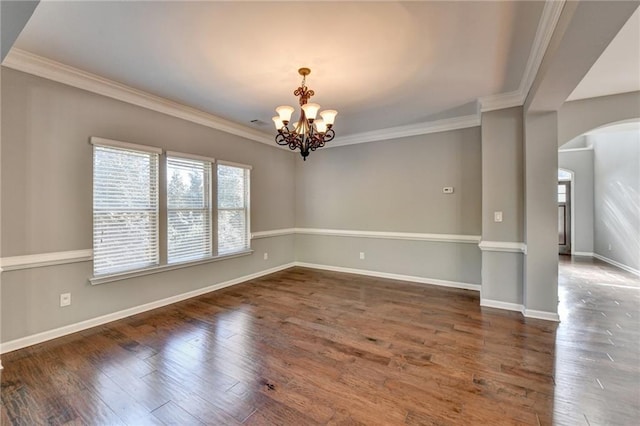 unfurnished room with plenty of natural light, ornamental molding, and a notable chandelier