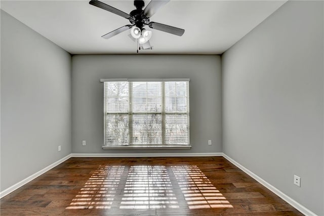 spare room with dark wood-type flooring and ceiling fan