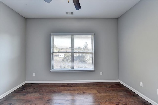 unfurnished room with ceiling fan and dark hardwood / wood-style flooring