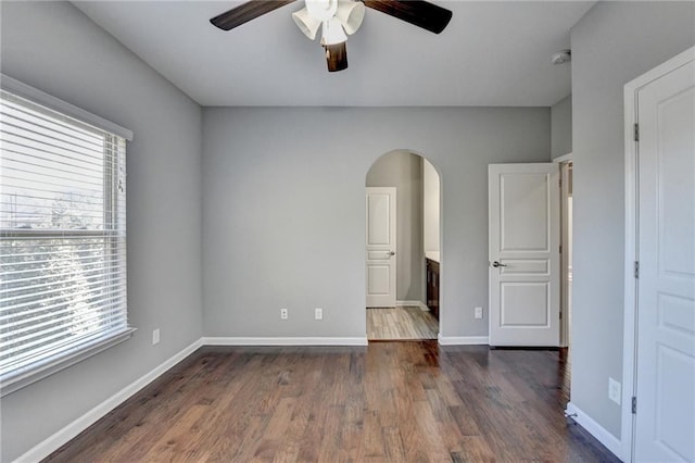 unfurnished bedroom featuring ceiling fan and dark wood-type flooring