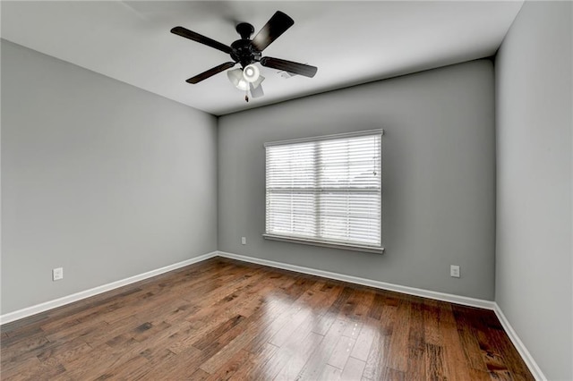 unfurnished room featuring ceiling fan and dark hardwood / wood-style flooring