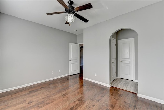 unfurnished bedroom featuring dark hardwood / wood-style floors and ceiling fan