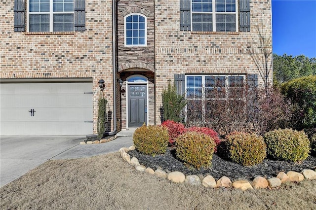 doorway to property with a garage