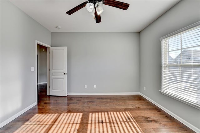 spare room with ceiling fan and dark hardwood / wood-style flooring