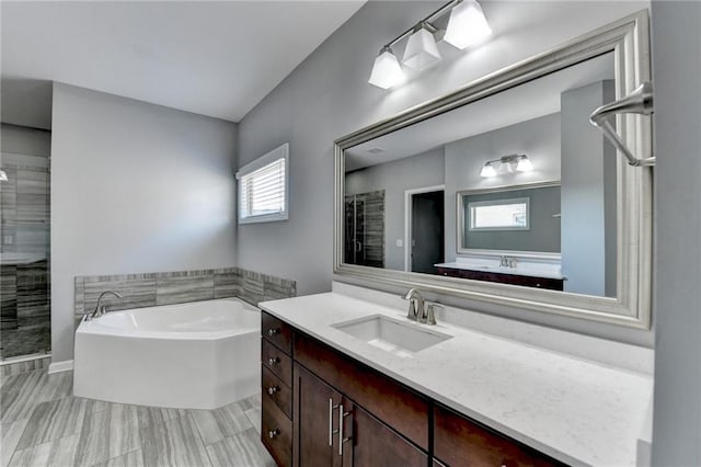 bathroom featuring vanity and shower with separate bathtub