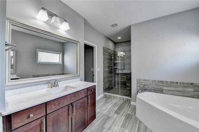 bathroom featuring plus walk in shower and vanity