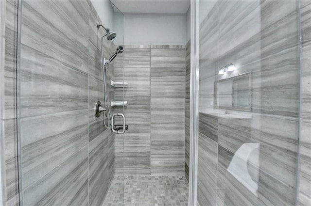 bathroom with a shower with door