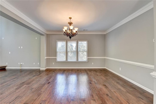 unfurnished room featuring a notable chandelier, ornamental molding, and dark hardwood / wood-style flooring