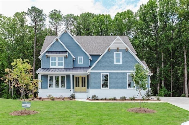 craftsman inspired home with a front yard and french doors